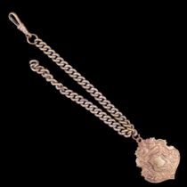 A late 19th / early 20th Century brass curb-link watch chain and fancy shield-shaped fob, 24 cm
