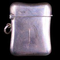 A George V silver fob vesta case, of subtly waisted cushion form and bearing an engraved initial "