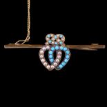 An antique romantic turquoise and pearl bar brooch, being a pair of interlocking hearts surmounted