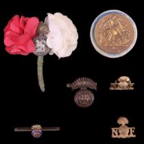 A small group of Northumberland Fusiliers badges and sweetheart brooches together with a related