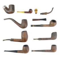 A group of vintage tobacco pipes including a diminutive carved wooden mask bowl