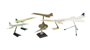 A collection of model British Airways Concorde aircraft, largest 31 cm long