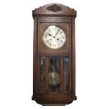 A 1940s oak wall clock having a two train movement, 79 cm x 33 cm x 16 cm