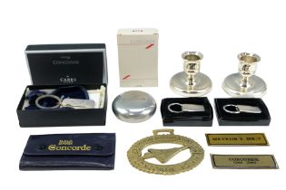 A group of British Airways Concorde collectables including two candlesticks, key rings, playing