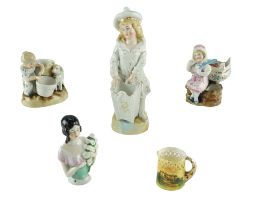 Two late 19th / early 20th Century European porcelain figural spill vases together with a similar