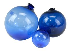 Three cobalt glass floats