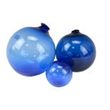 Three cobalt glass floats