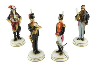 Four Michael Sutty limited-edition hand-painted porcelain military figurines comprising "Junior