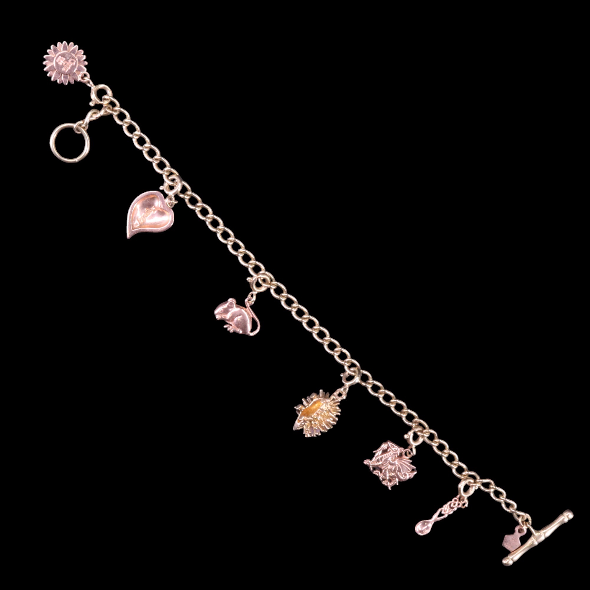 A contemporary Clogau Welsh 9 ct rose and yellow gold charm bracelet, the curb link chain carrying - Image 2 of 5