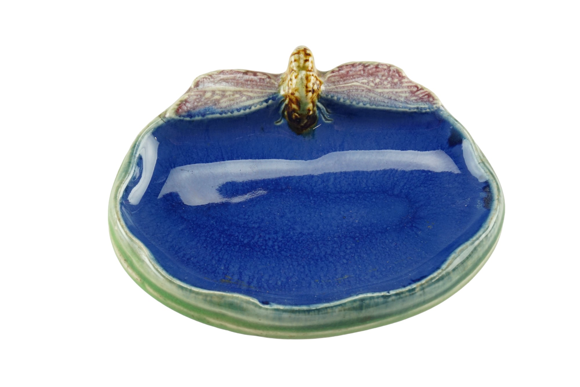A Royal Doulton majolica soap dish modelled as a dragonfly perched on the edge of a pond,