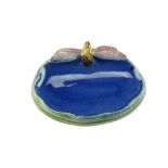 A Royal Doulton majolica soap dish modelled as a dragonfly perched on the edge of a pond,