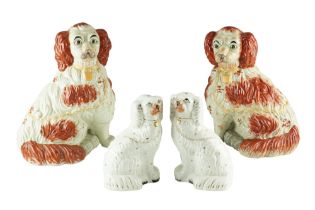 A pair of Victorian Staffordshire dogs together with a larger later pair, tallest 34 cm