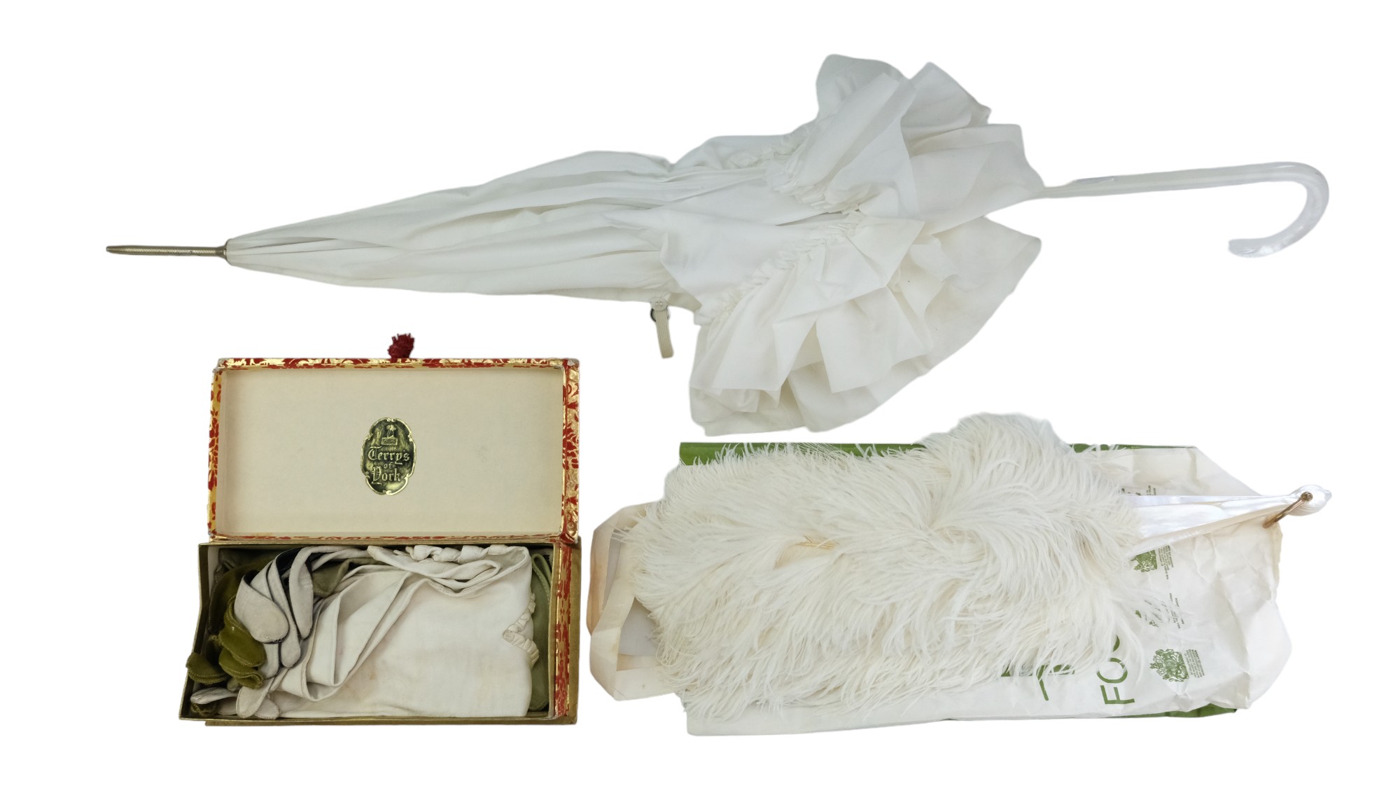 A group of vintage ladies' dressing accessories comprising white kid skin and other gloves, a faux