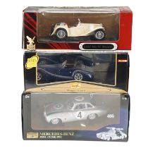 Three boxed diecast model cars comprising a 1947 MG TC Midget, a Morgan Aero S and a 1952 Mercedes-
