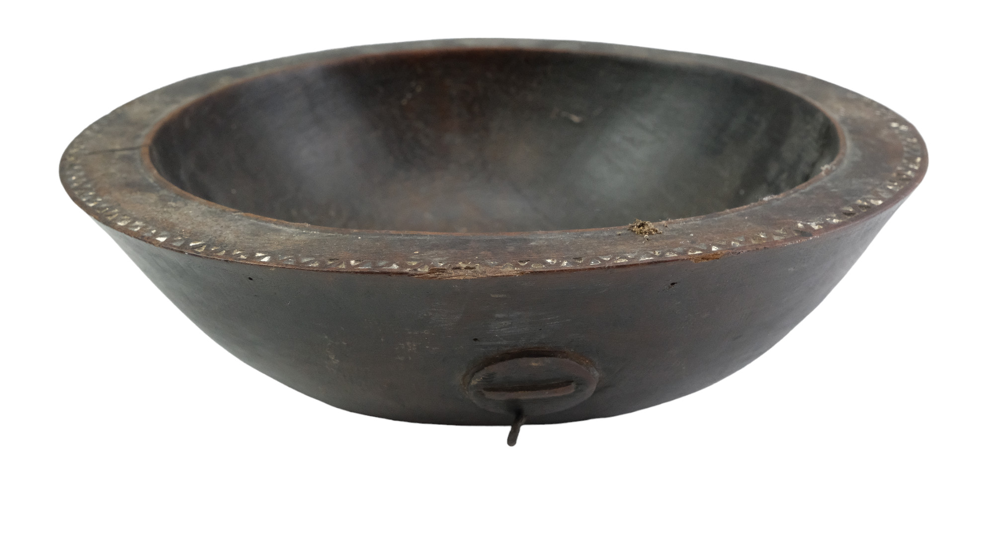 An antique African carved hardwood bowl, its planar rim having an inner cockbead and outer chip-