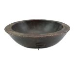 An antique African carved hardwood bowl, its planar rim having an inner cockbead and outer chip-