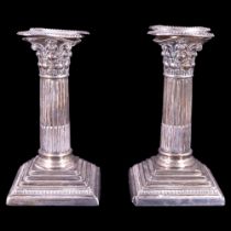 A pair of Edwardian silver Corinthian columnar candlesticks, William Hutton & Sons Ltd, London,