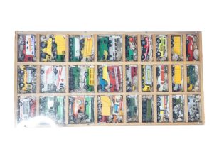 A group of vintage diecast cars, vans and other vehicles in a wood and Perspex display case, 54 x