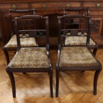A set of four George III mahogany dining chairs having cable backs and sabre legs