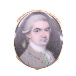 A George III portrait miniature of a gentleman in powdered wig wearing a grey frock coat, green