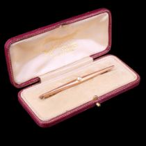An elegant pearl-set 9 ct yellow metal bar brooch, comprising a 4 mm pearl set at the centre of a
