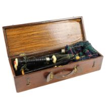 A set of great Highland bagpipes, in turned black wood with ivorine and nickel plated mounts, the