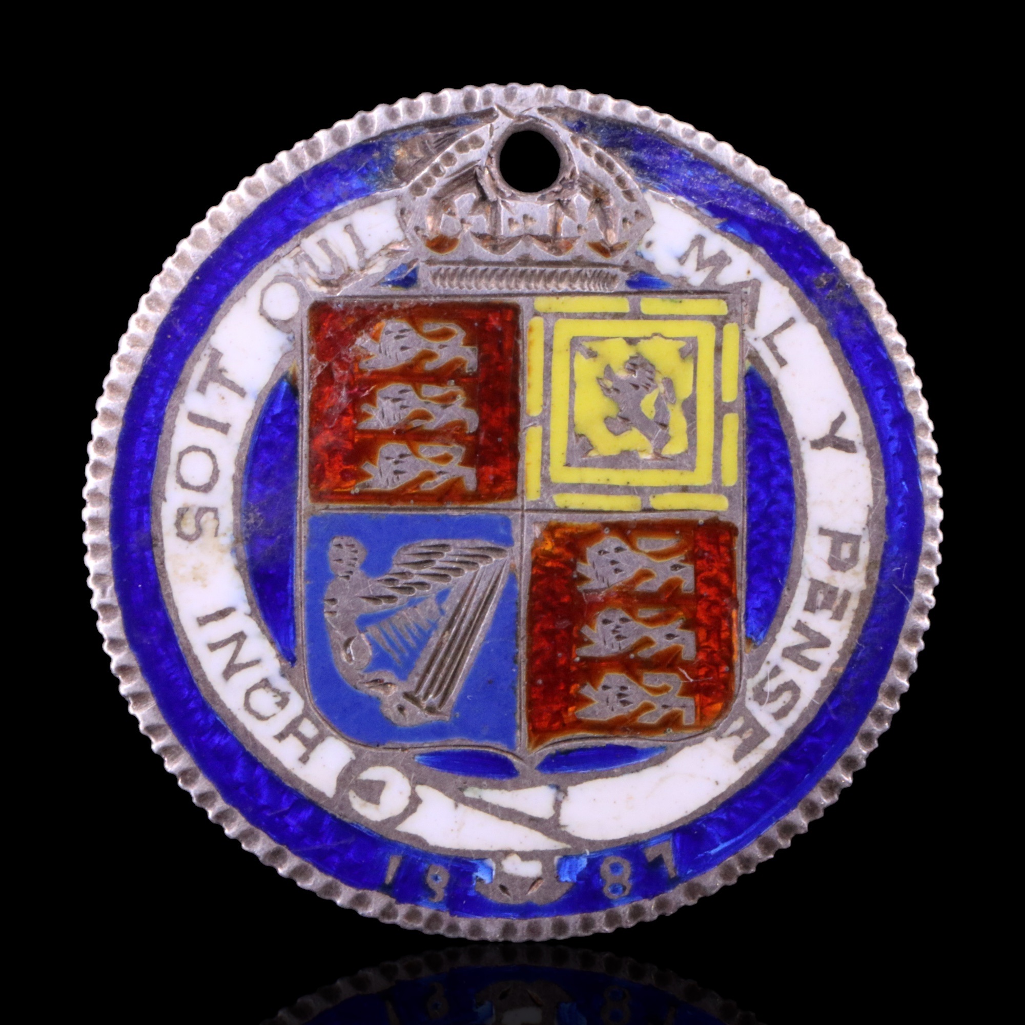 An 1887 Jubilee silver shilling coin brooch, enameled in the manner of Edwin Steel and Probert.