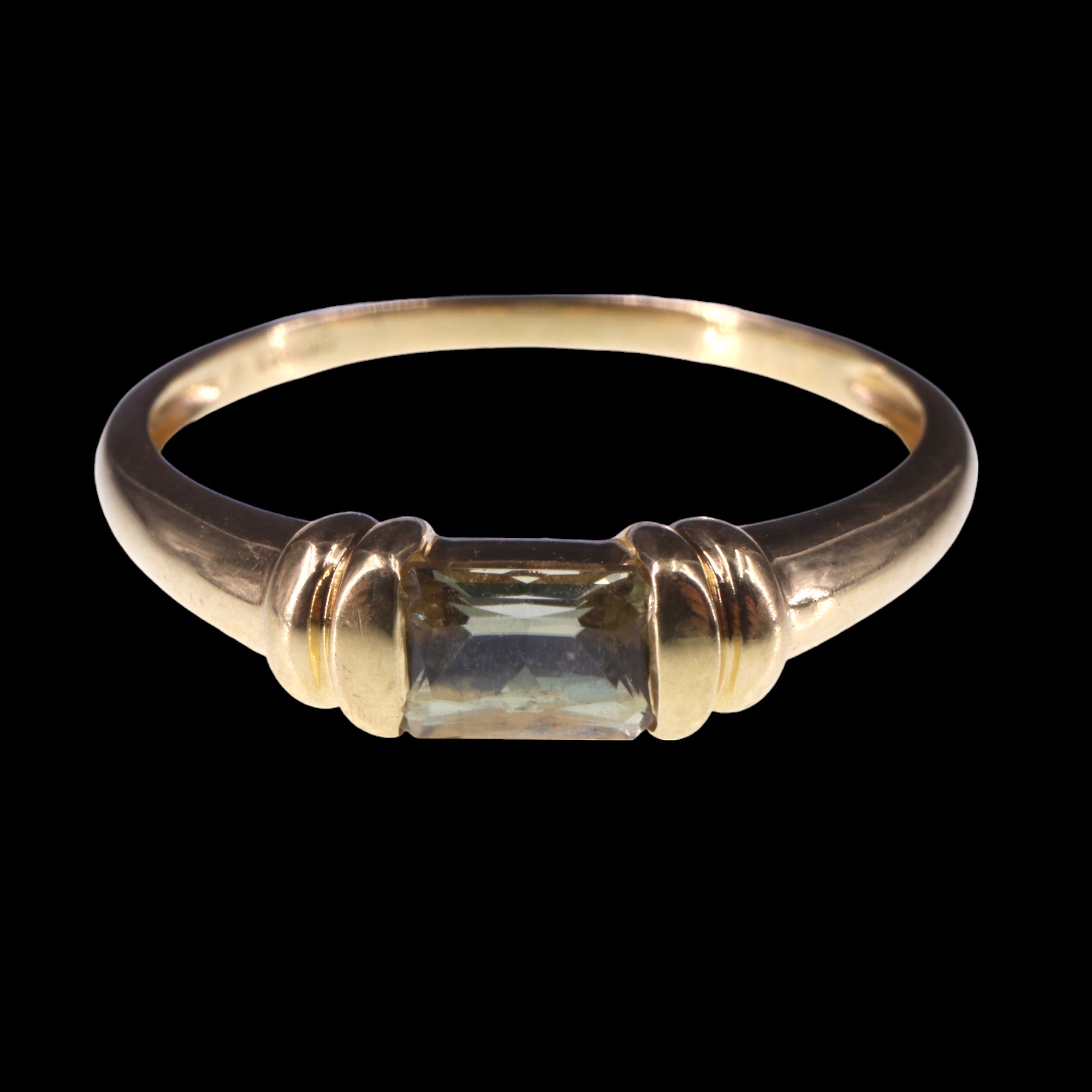 A pale yellow topaz finger ring, the emerald cut stone clinched between paired collars on an 18 ct - Image 2 of 4