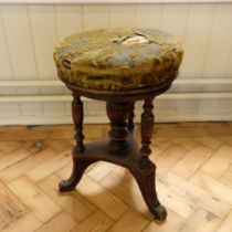 A Victorian turned and carved piano stool