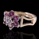 A 1970s diamond and red spinel flower-head ring, the central illusion-set diamond set within six