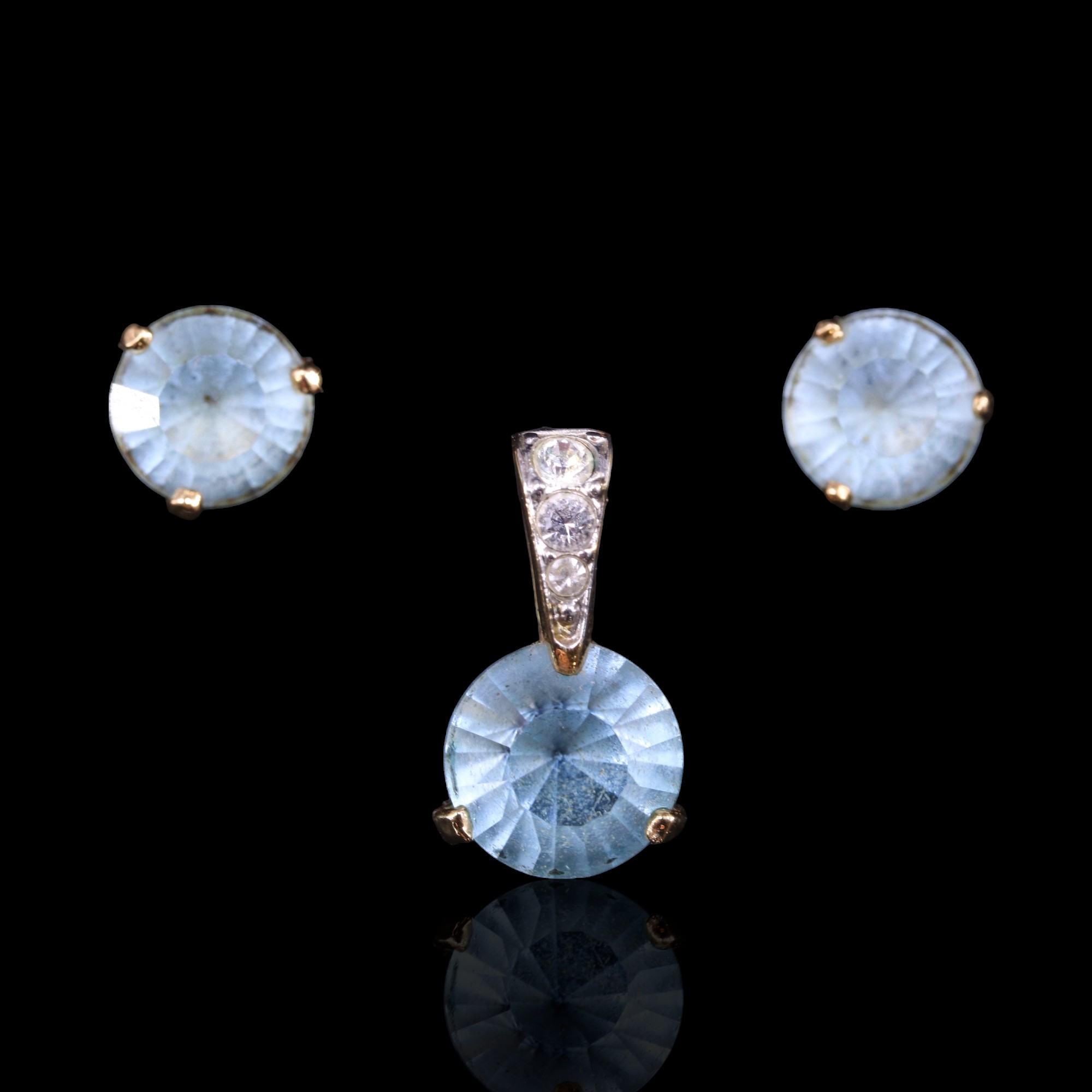 A Swarovski blue crystal pendant together with a pair of similar stud earrings