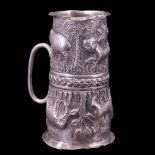 An antique Indian silver double spirit measure, relief decorated in depiction of wild animals and