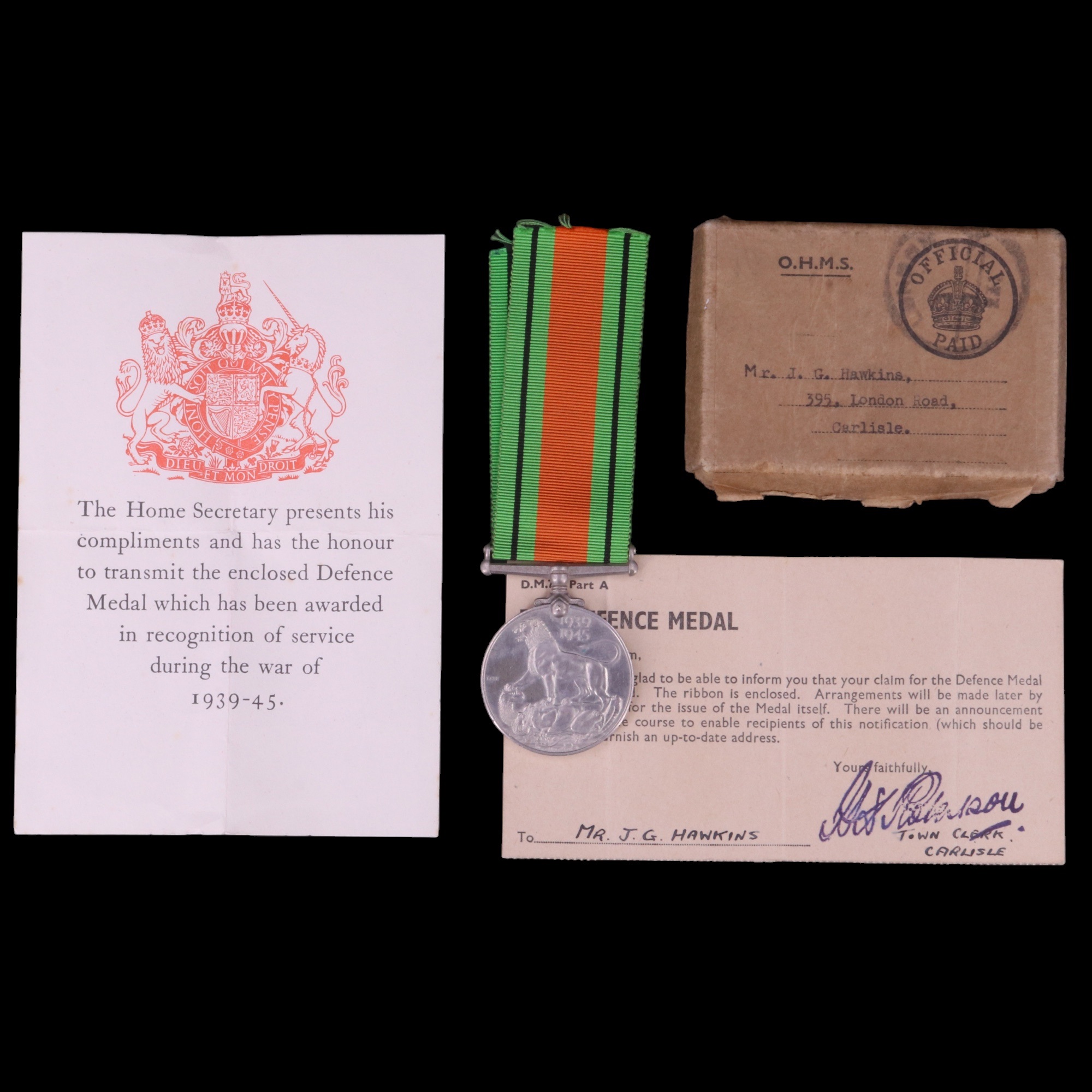 A 1939-1945 War Defence medal, in carton addressed to Mr J G Hawkins of Carlisle