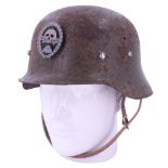 A Spanish M 1942 steel helmet with associated badge