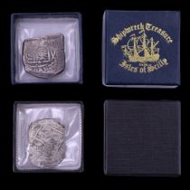 A "Shipwreck Treasure from Isles of Scilly" silver piece of eight coin fragment together with a