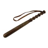 A turned wooden truncheon with leather wrist strap, 38 cm
