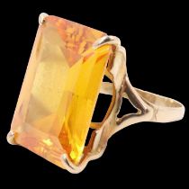 A mid 20th Century heliodore dress ring, the 18 x 13 mm emerald cut stone claw-set between the