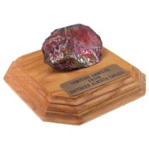 A specimen of ammolite gemstone from Alberta, Canada, mounted on an oak base, 14 cm