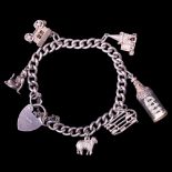 A vintage silver charm bracelet including gypsy caravan, nude and ship in a bottle charms, 29 g