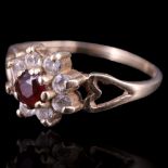 A garment and paste flowerhead cluster ring, the 9 ct gold shank having open heart-shaped shoulders,