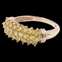 A contemporary chrysoberyl finger ring, having 25 brilliants, pave set in three curved rows, between