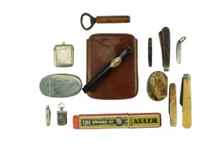 A group of collectors' items including an Edwardian pocket tobacco or snuff box, a nickel vesta