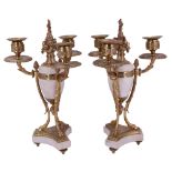 A pair of Louis XVI style gilt brass and alabaster three-branch candelabra, each comprising a