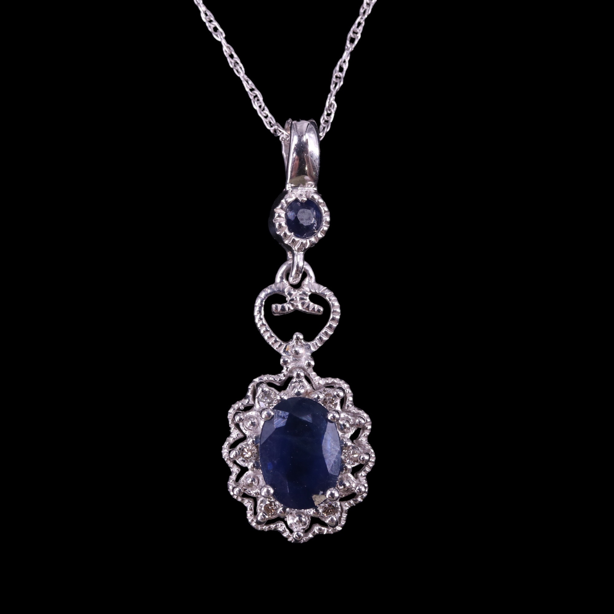 A contemporary articulated diamond and sapphire cluster pendant and chain comprising an oval-cut - Image 2 of 4