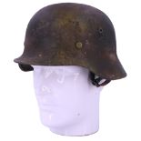 A German Third Reich steel helmet, re-painted and re-lined