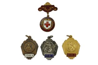 Three International Dancing Masters Association prize medals together with a British Red Cross