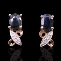 A pair of dark blue spinel, white stone and 9 ct yellow metal earrings, the oval cut spinels each of