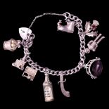 A vintage silver charm bracelet including spaceman and ship in a bottle charms, 47 g