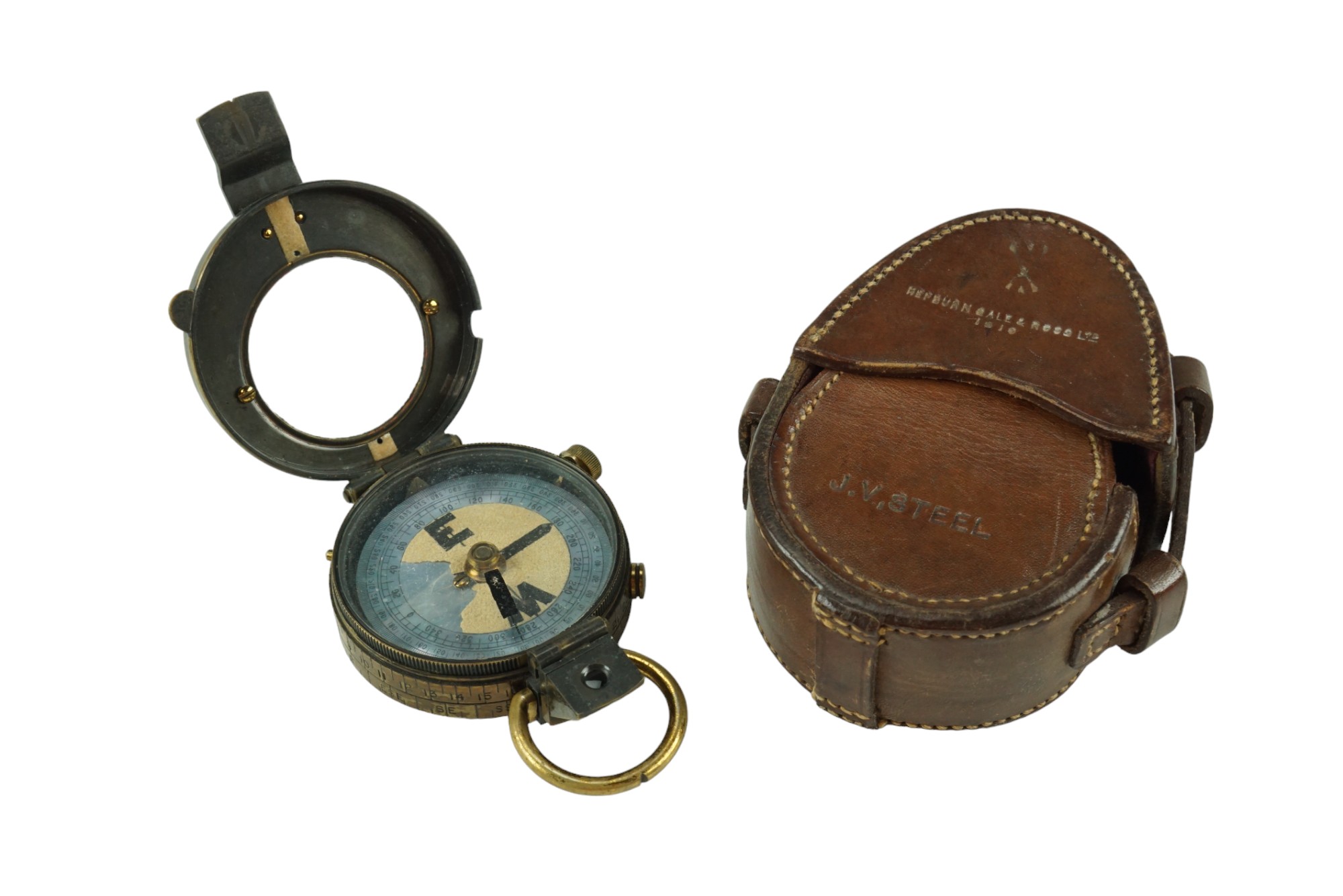 A 1910 date British army prismatic marching compass and leather case, each marked with the name J