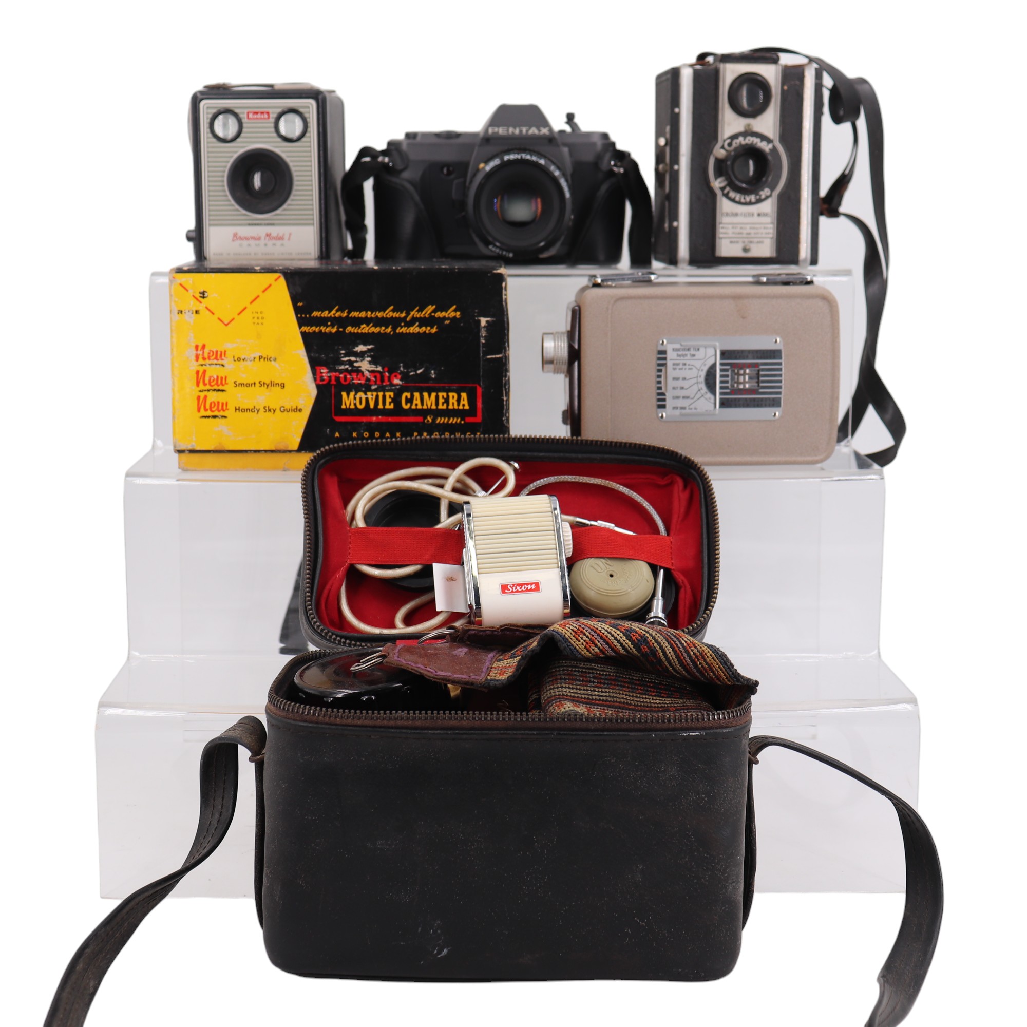 Three 1950s film and cine cameras comprising a cased Kodak Brownie Model I, a Coronot Twelve-20